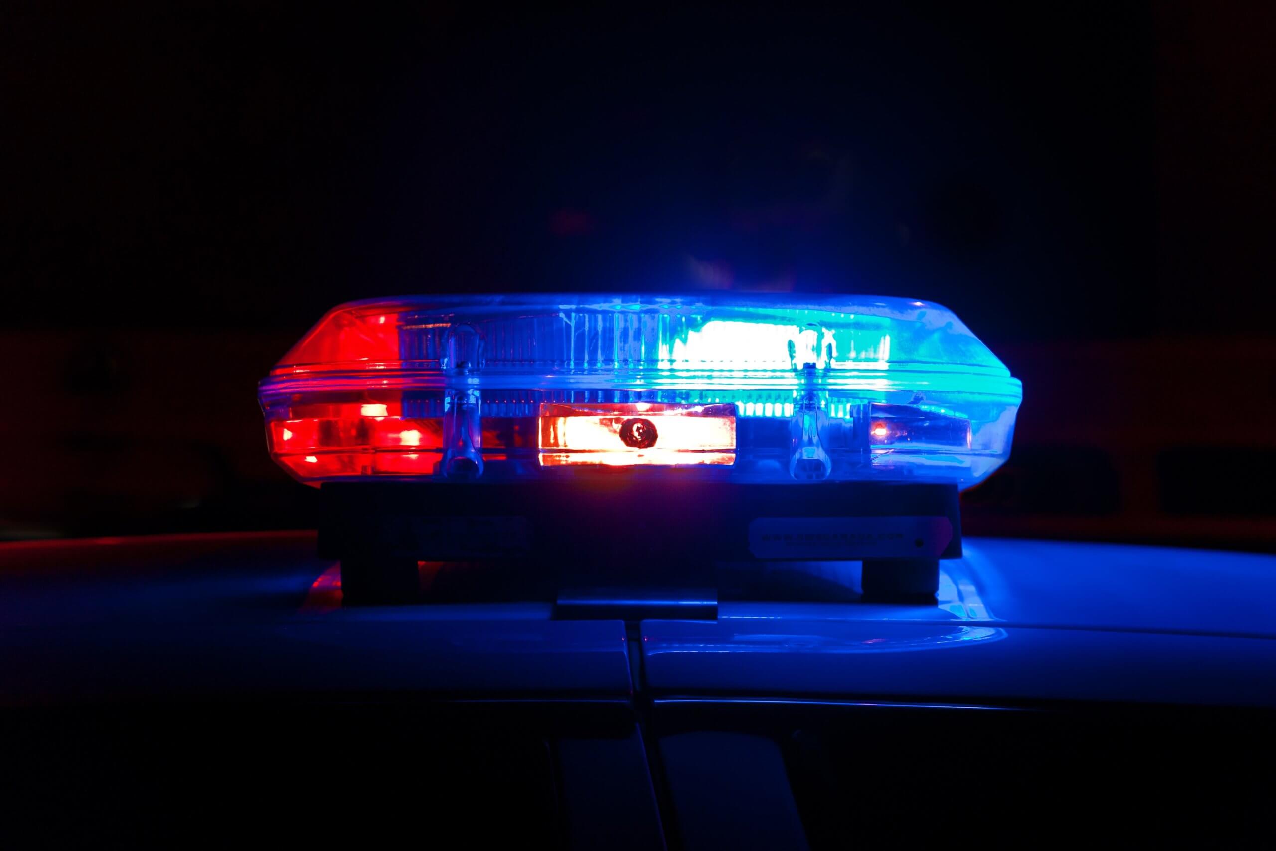 Red & Blue Police Lights On Top of a Police Car During a DUI Arrest