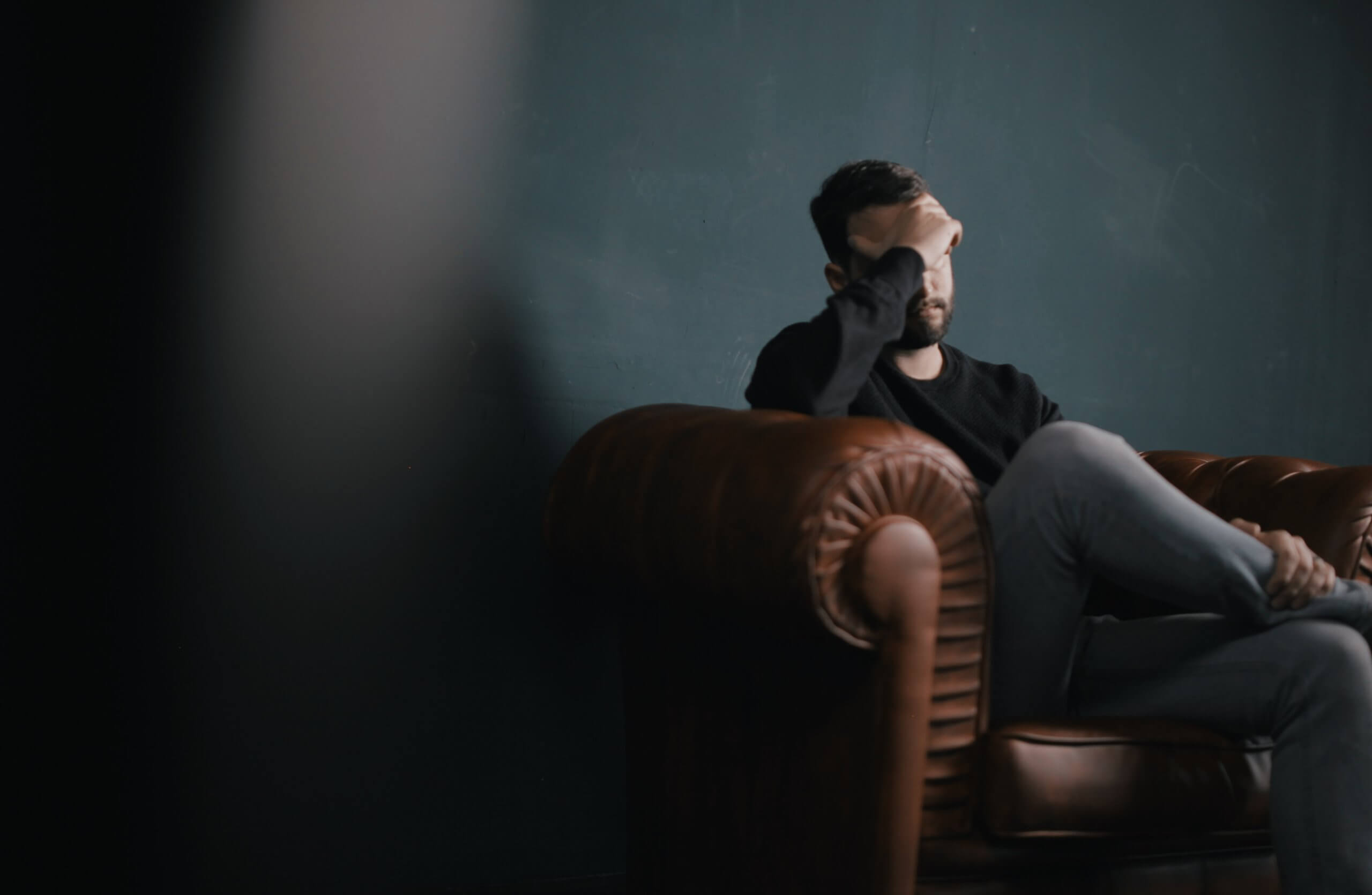 Emotional Distress, Man Sitting on Leather Couch