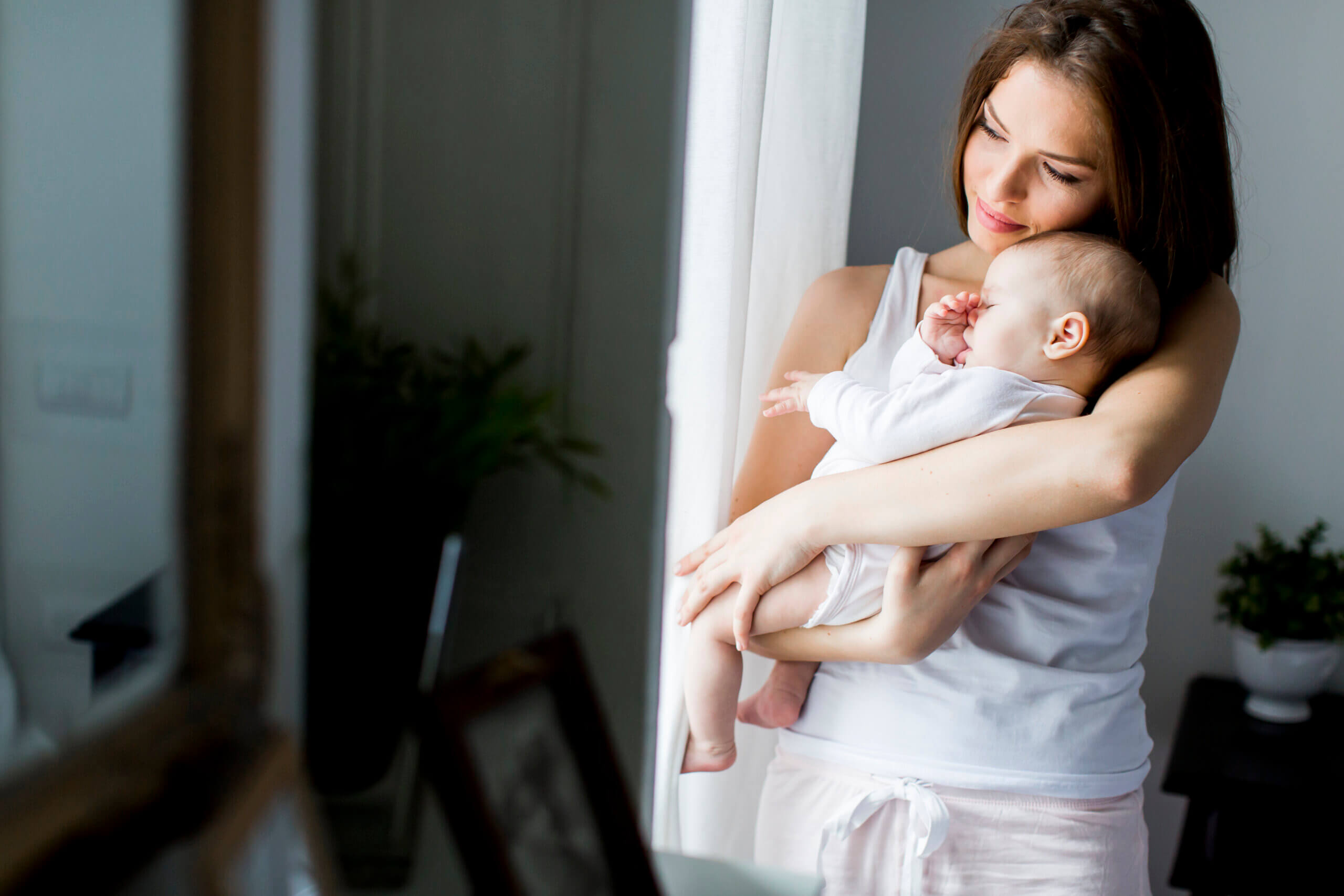 Happy mother with newborn baby girl. Baltimore birth injury lawyer.