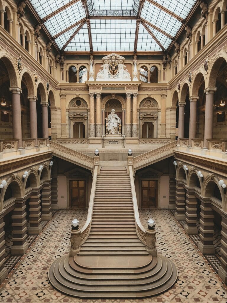 Majestic staircase inside a historic palace in Vienna, showcasing classic architecture.